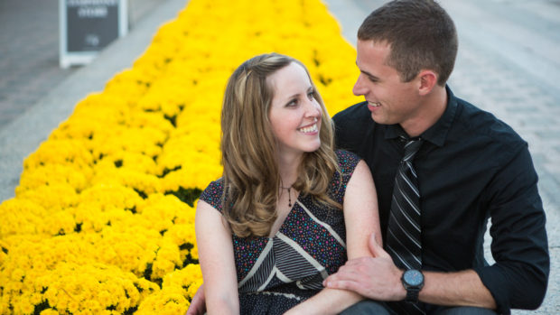engagement photography of a couple in dallas with yellow flowers in the background.